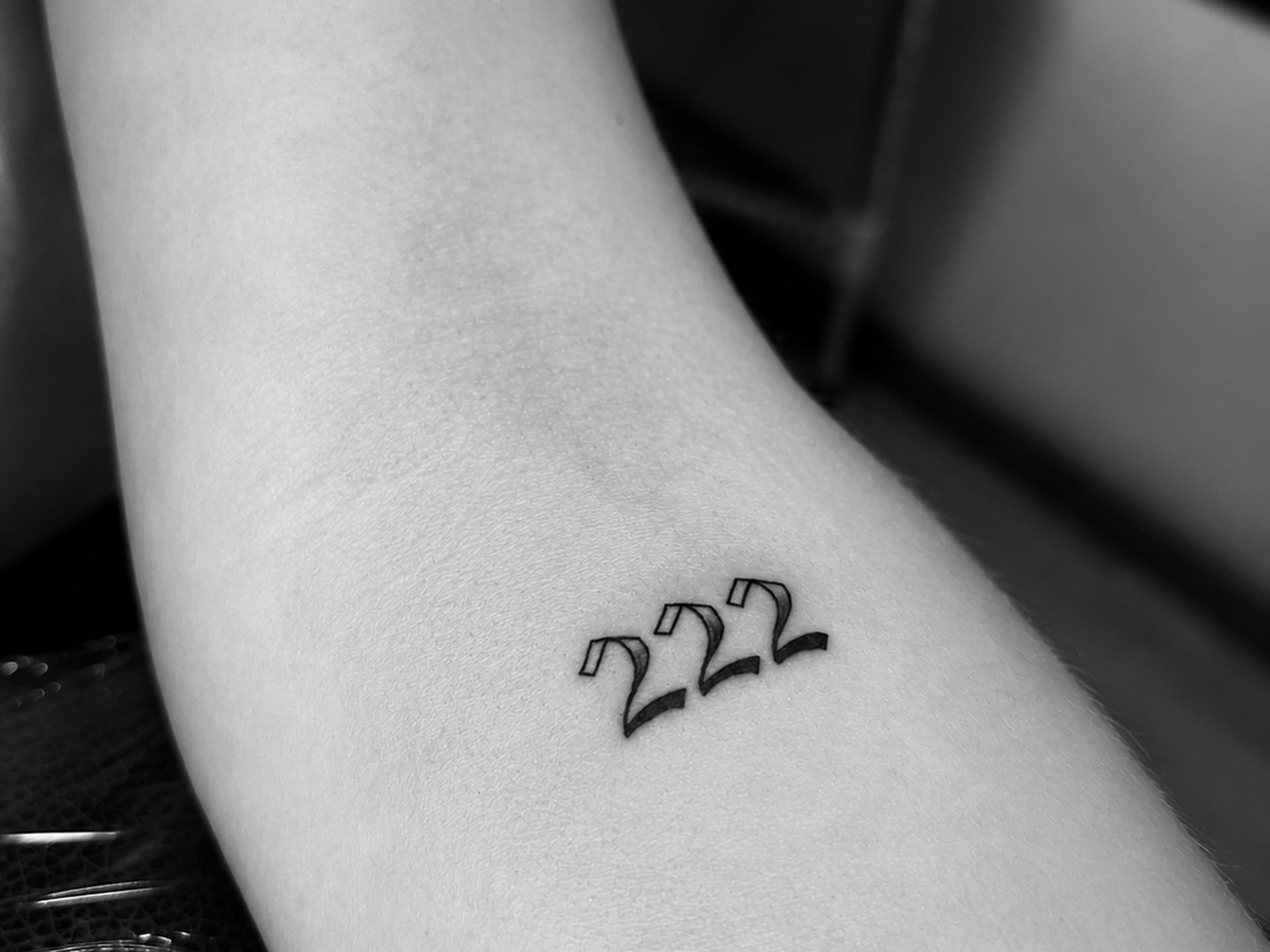Tatuaje minimalista con número angelical 222